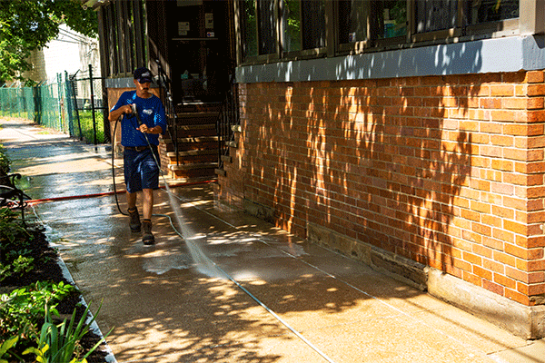 Hydro Savage Pressure Washing technician sealing concrete