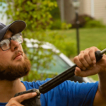 Hydro Savage Pressure Washing technician soft washing a home with a company vehicle in the background
