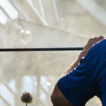 Rear view of a Hydro Savage Pressure Washing technician soft washing vinyl siding