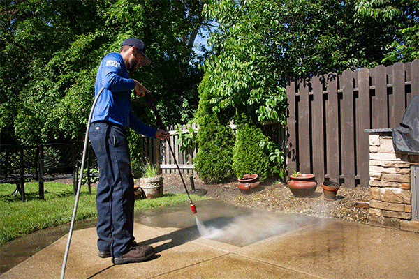 Power washing a concrete patio