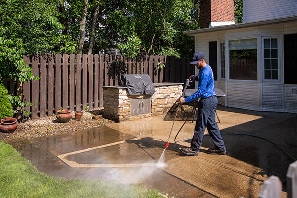 Power washing a concrete patio