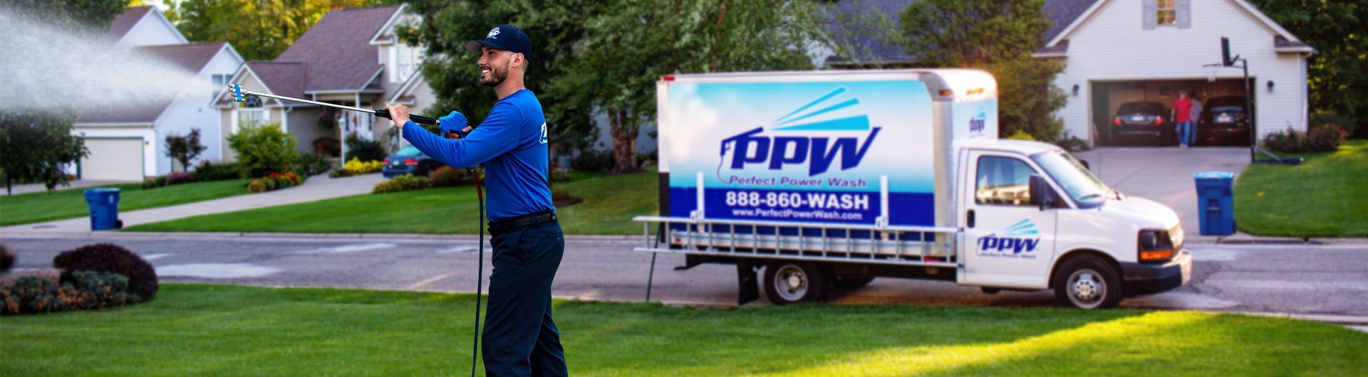 Photo of a Hydro Savage Pressure Washing technician washing a house