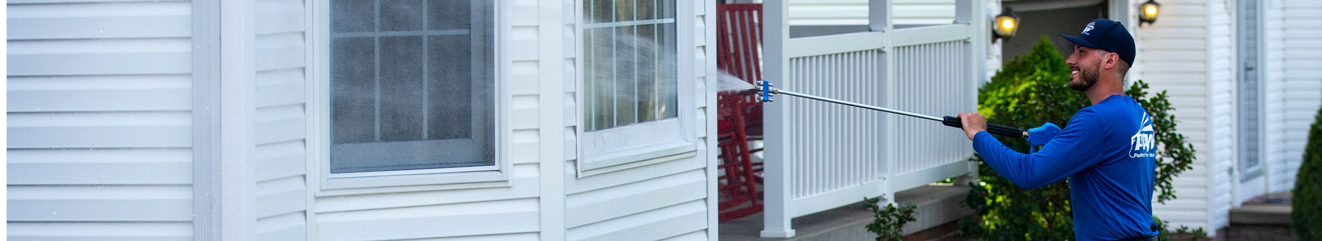 Power Washing the Siding of a White House
