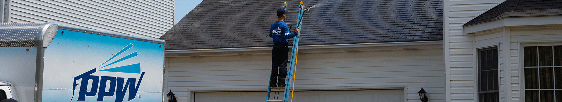 Hydro Savage Pressure Washing technician performing a roof treatment
