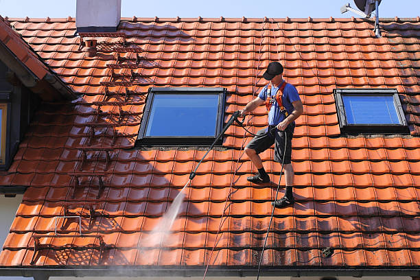 How it works: Power washing technician performing a low-pressure roof treatment.